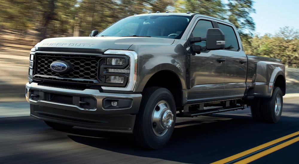Grey 2026 Ford F-250 for sale in Rhinebeck driving down a road.