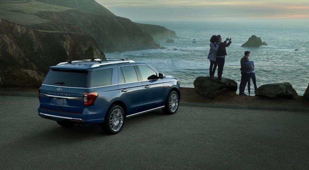 Rear of a blue 2023 Ford Expedition parked near an ocean after visiting a used car dealer in Rhinebeck.