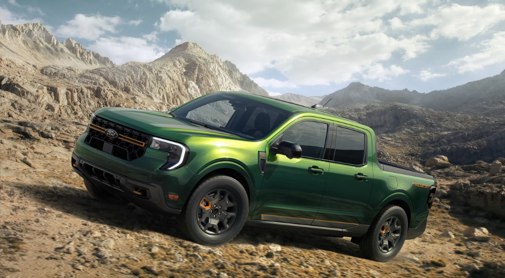 Green 2025 Ford Maverick driving on a trail