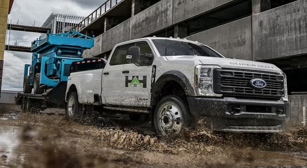 A white 2025 Ford F-350 towing a trailer.