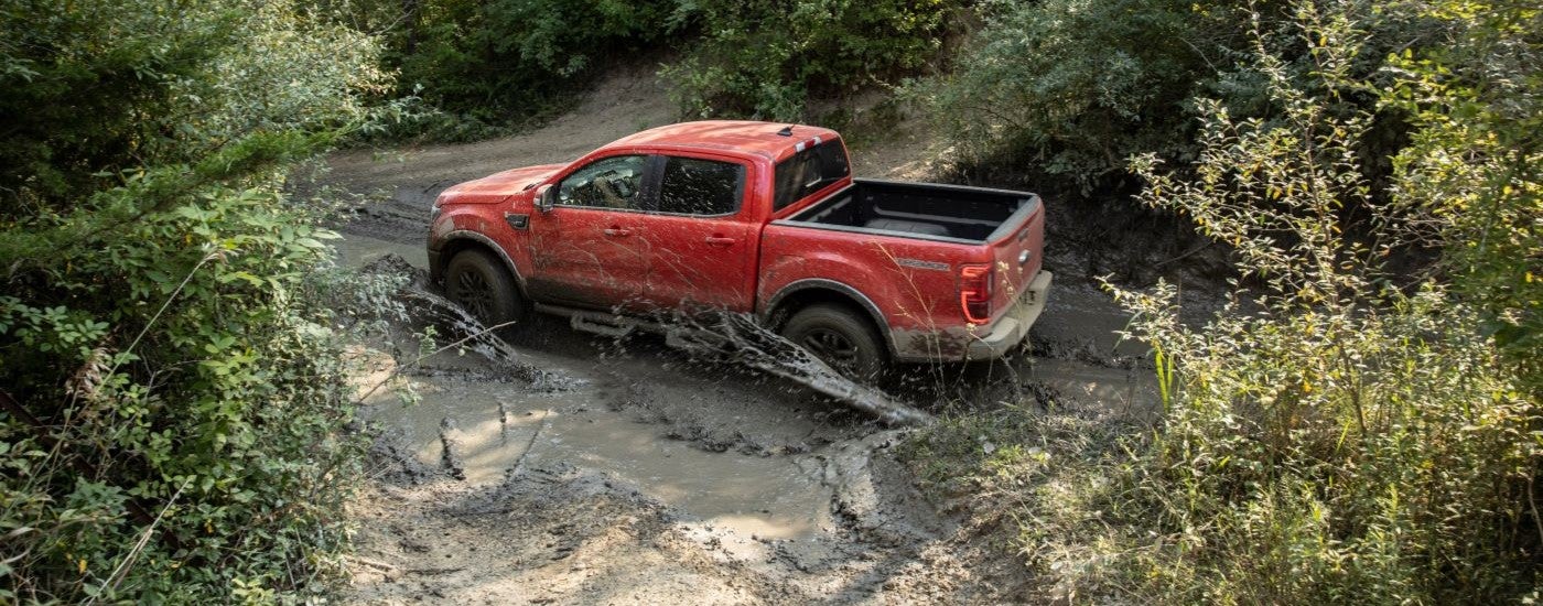 Orange 2021 Ford Ranger Tremor driving through mud