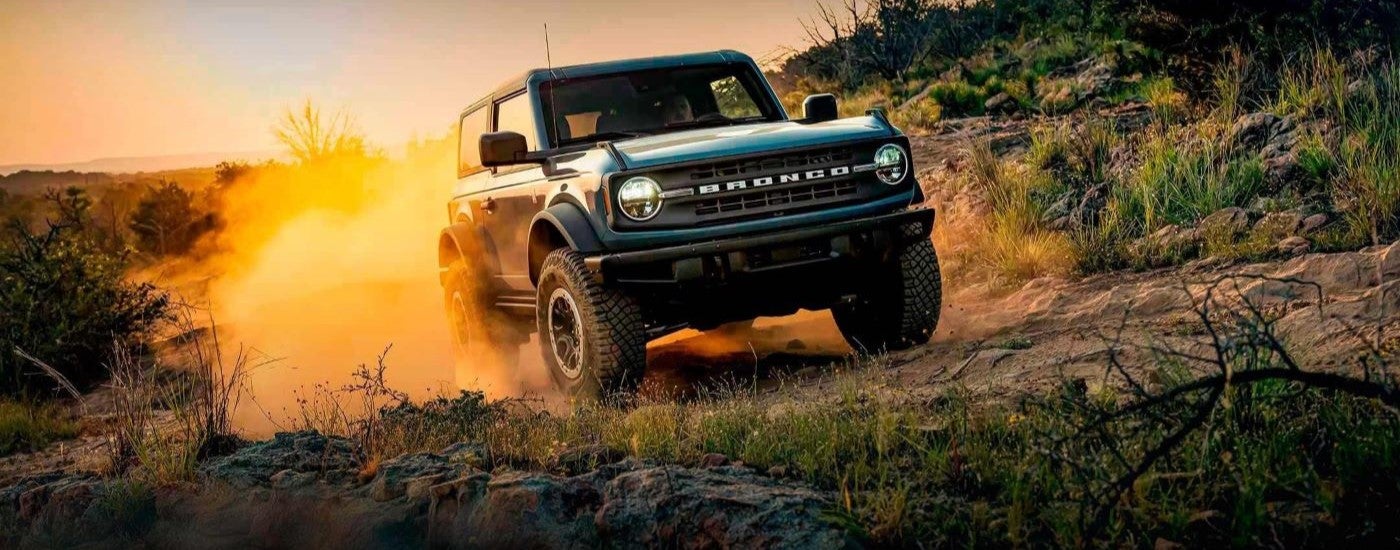 Blue 2022 Ford Bronco driving off-road.