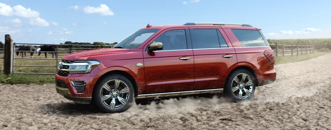 Red 2023 Ford Expedition King Ranch driving to look at SUVs for sale