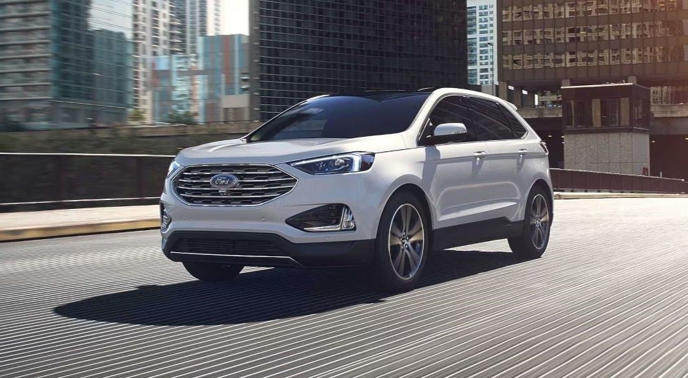 White 2024 Ford Edge driving over a bridge.