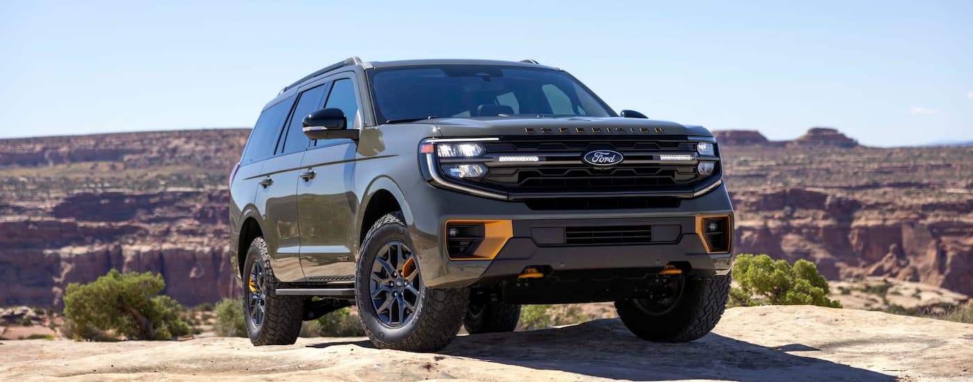 Green 2026 Ford Expedition Tremor parked off-road on a hill.