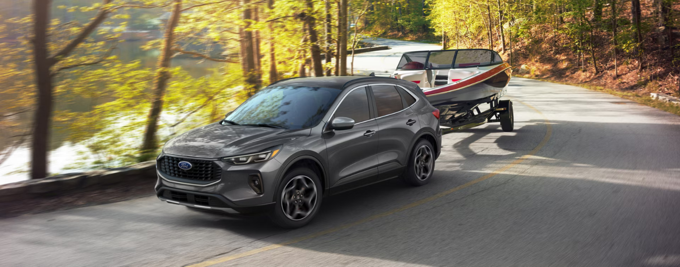 Grey 2026 Ford Escape towing a boat