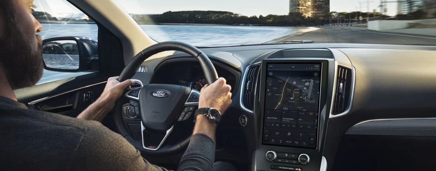 Person driving a 2022 Ford Edge ST to a Ford dealer
