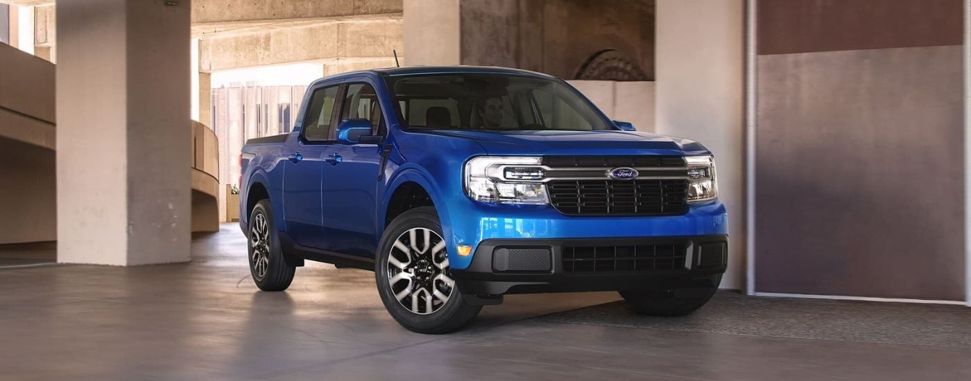 Blue 2022 Ford Maverick is driving through a parking garage