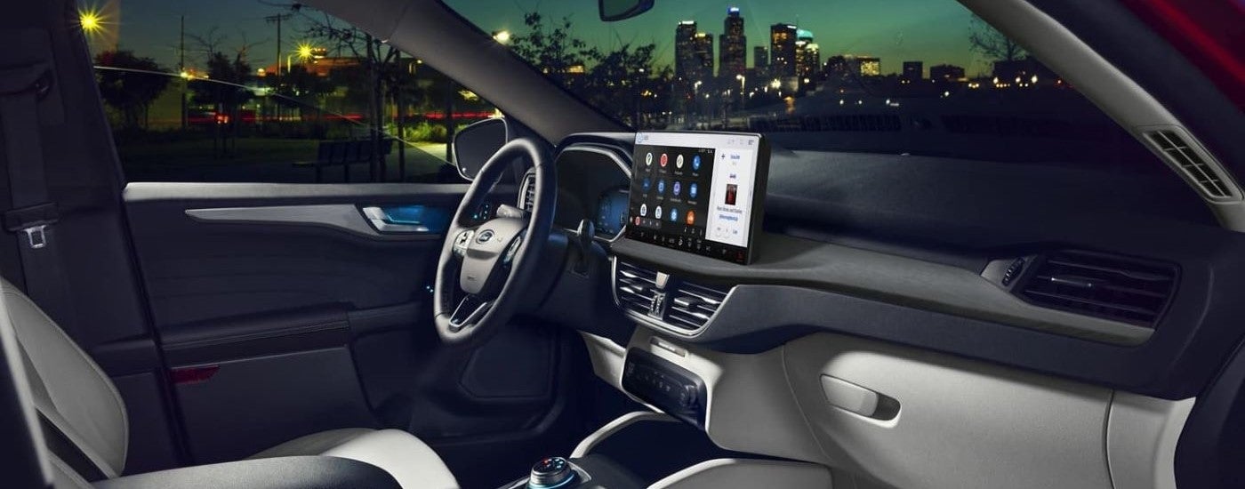 The black interior, steering wheel, and dashboard of a 2024 Ford Escape.