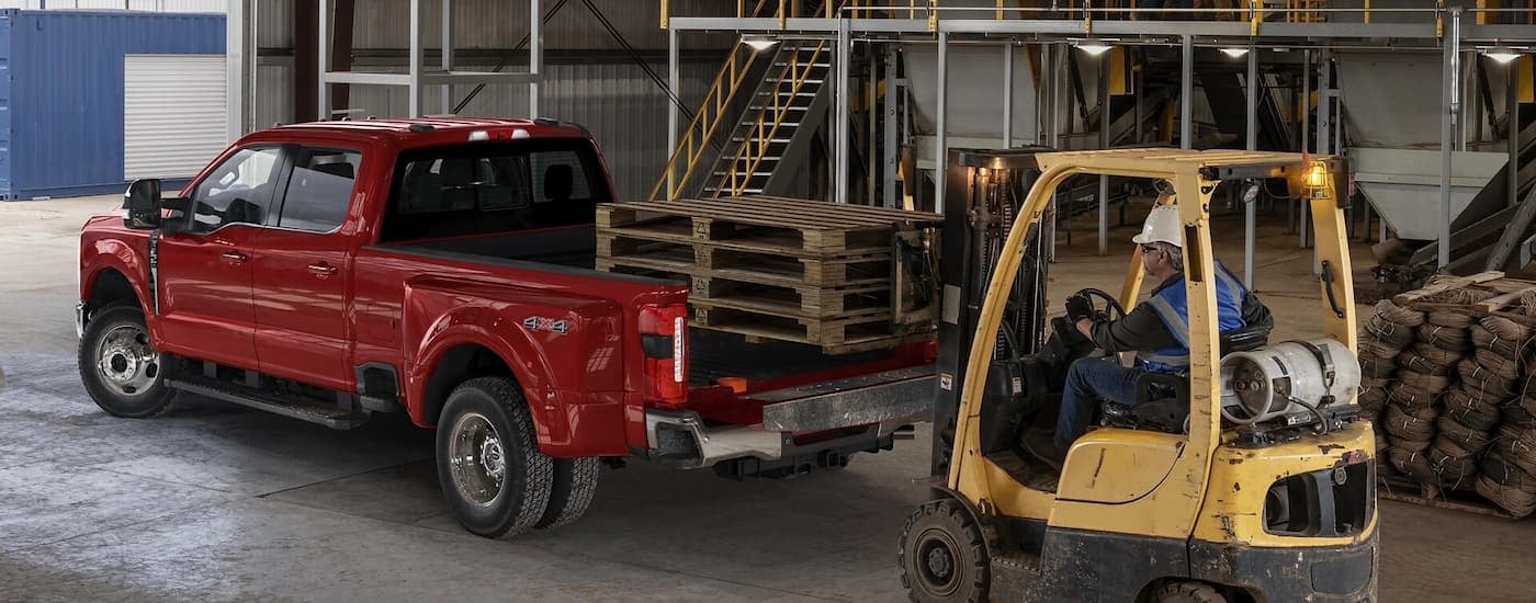 Red 2025 Ford F-350 hauling pallets in a warehouse