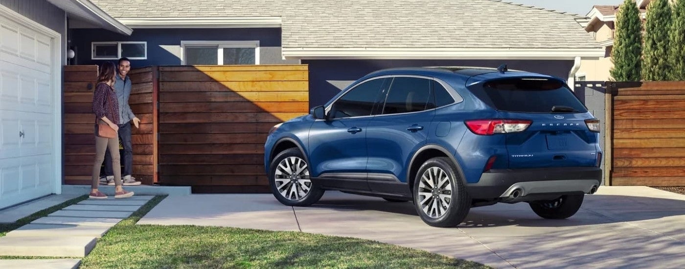 A blue 2022 Ford Escape Titanium parked on a driveway.