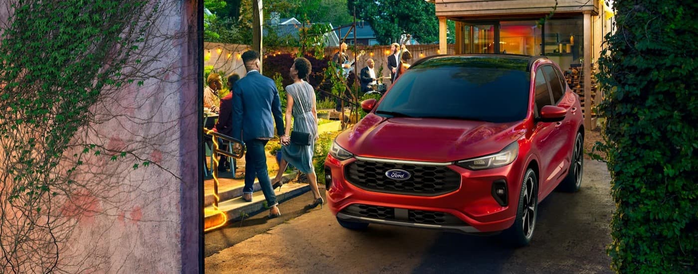 A red 2024 Ford Escape parked on a driveway.