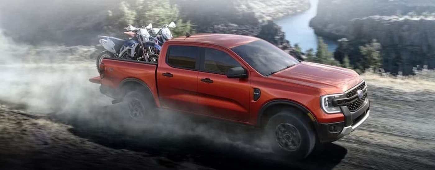 A red 2024 Ford Ranger driving offroad.
