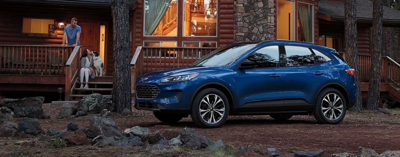 Blue 2021 Ford Escape parked near a cabin