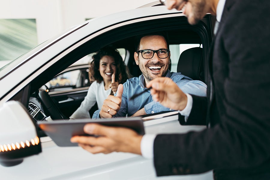 happy man and woman in the car